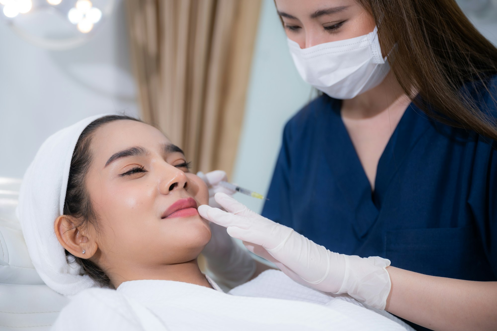 young Asian woman making cosmetology treatment skin injection, Mesotherapy of face beauty care