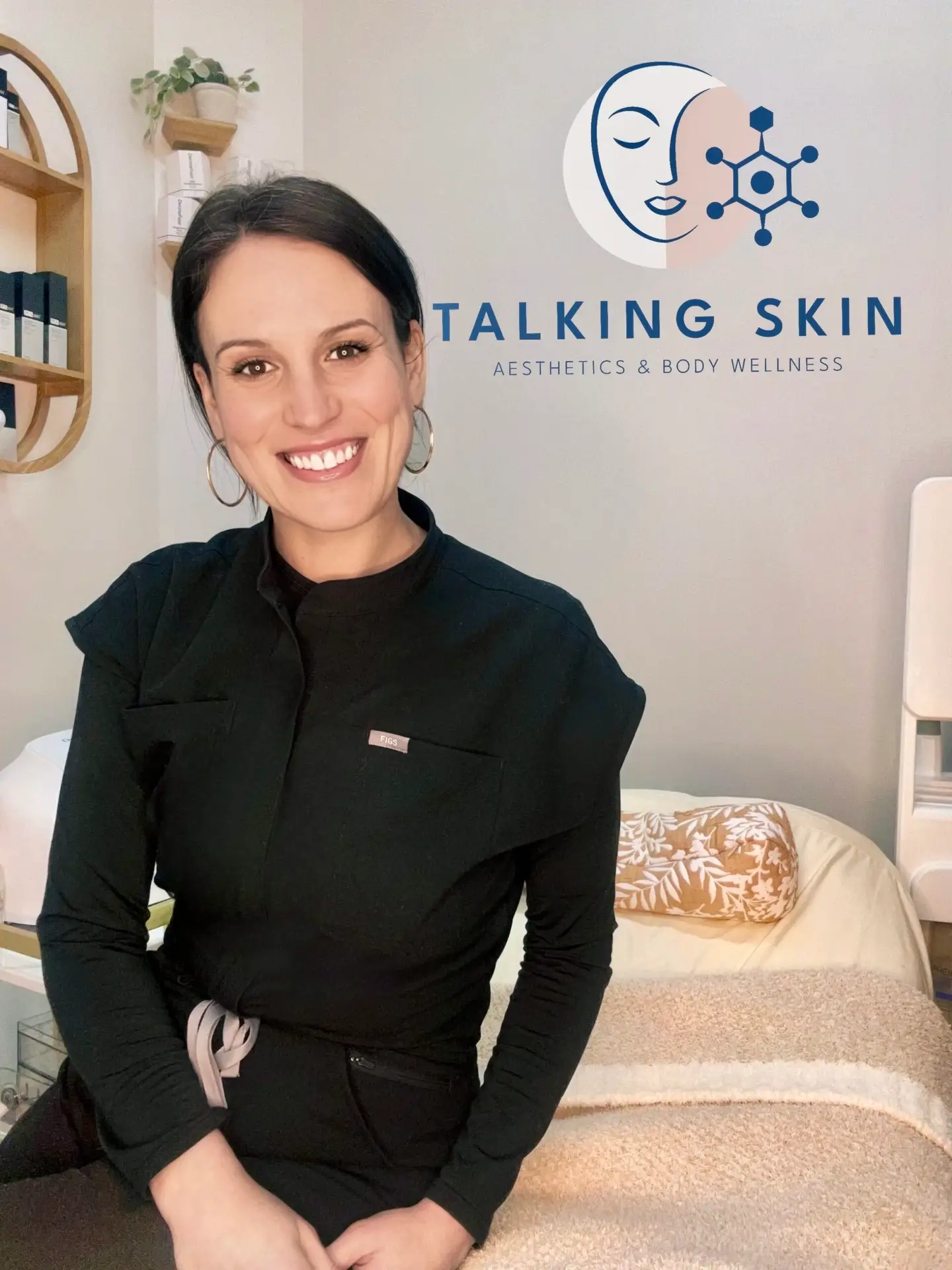 owner of talking skin sitting on facial bed